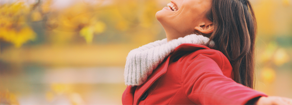Woman smiling in autumn weather wearing jacket