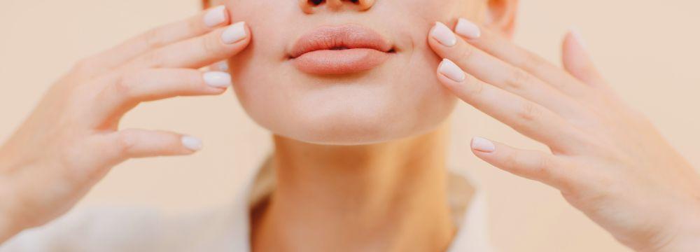 woman holding tight skin after tightening treatment