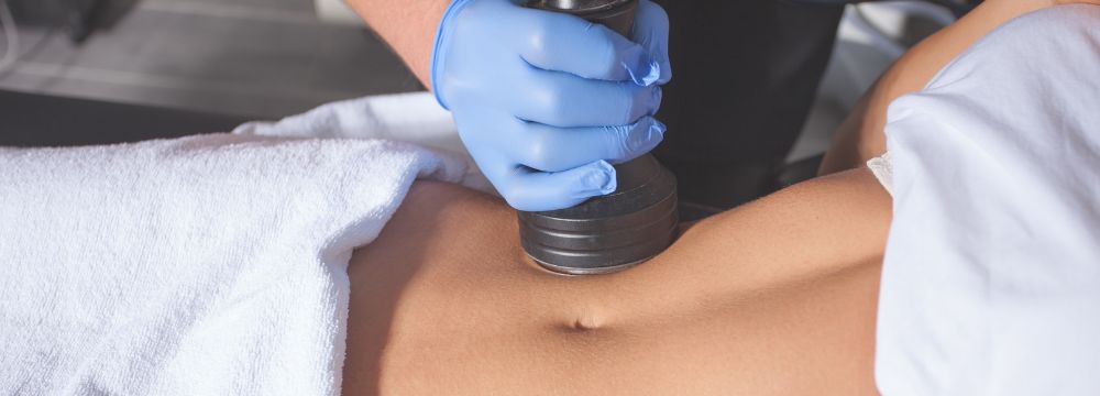 Woman receiving body contouring on stomach 