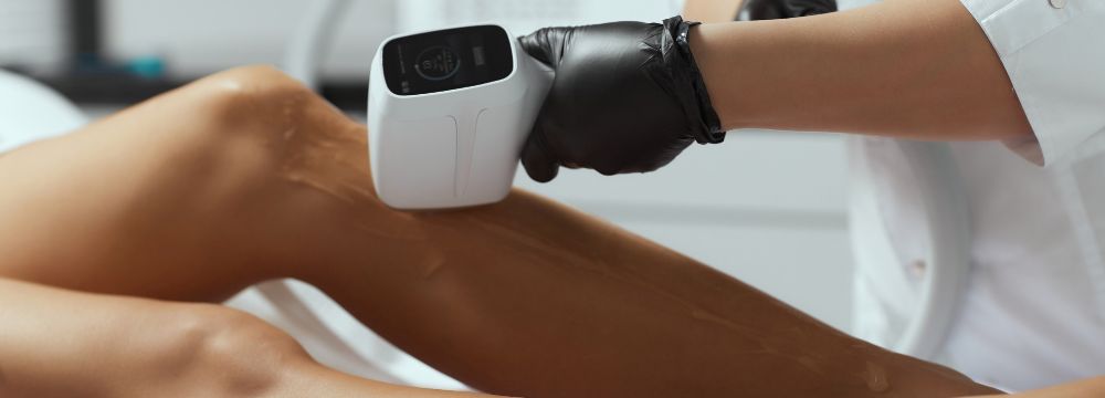 Woman receiving laser hair removal on legs 