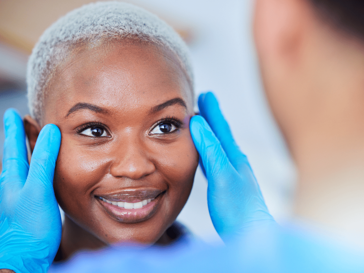 patient in exam room chair having consultation with doctor