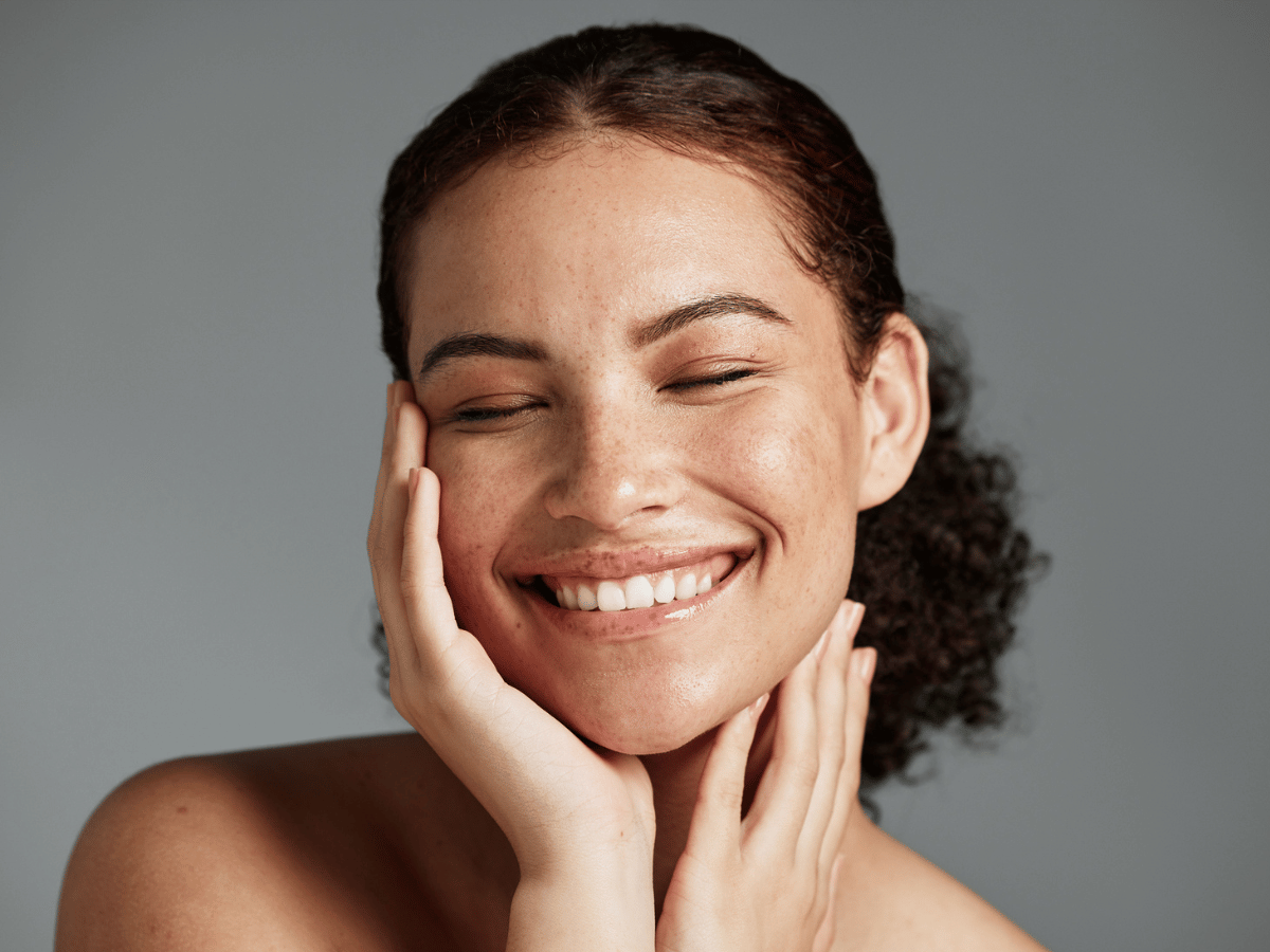 smiling woman close up photo over grey backdrop