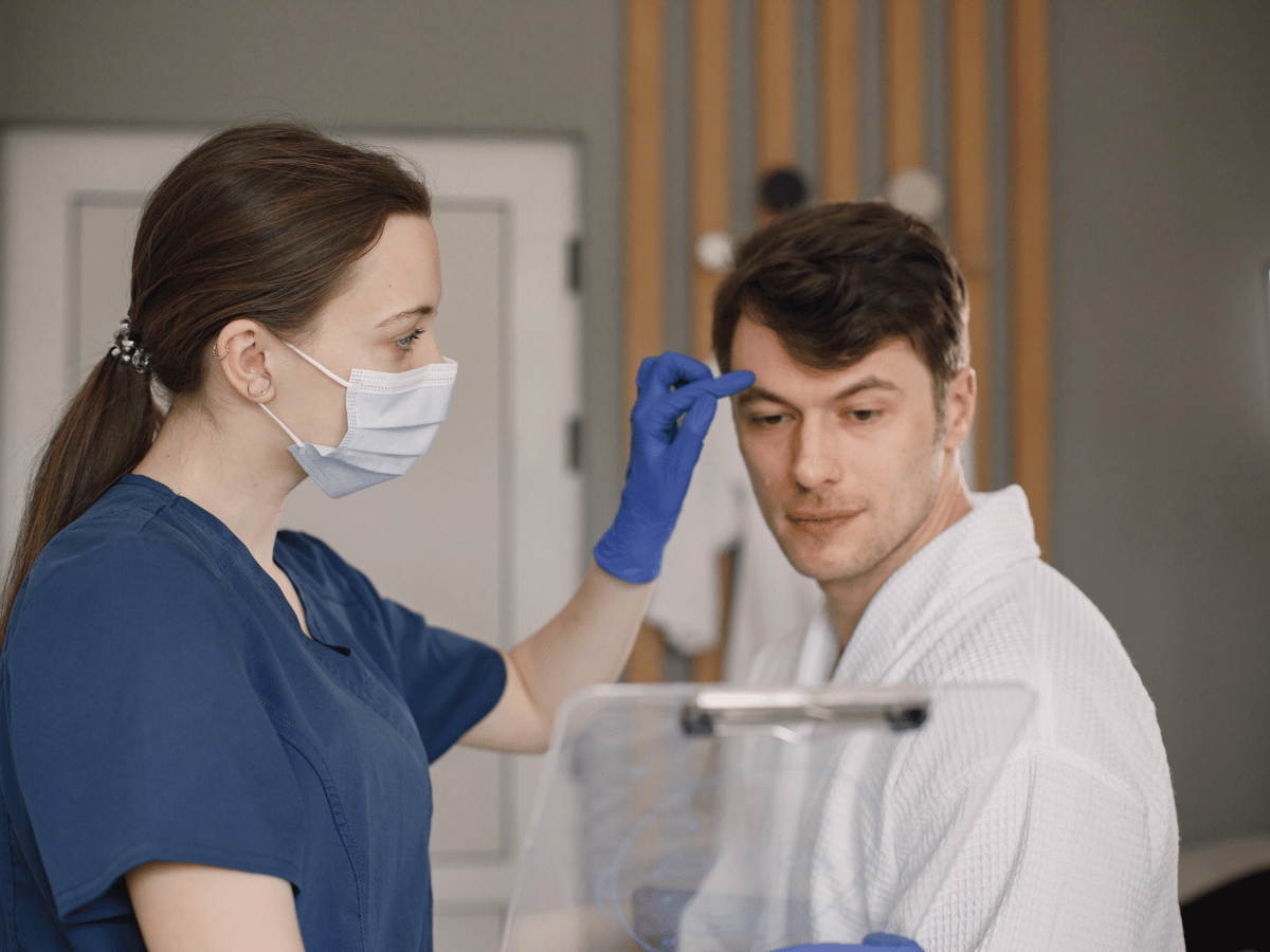 patient in exam room chair having consultation with doctor